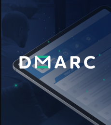 In white, the letters "DMARC", with the "M" stylistically an envelope, over a blue-tinted image of a screen showing an inbox with a man's profile in the background 